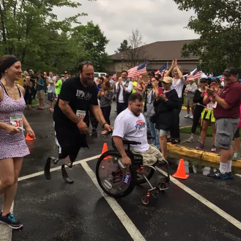 2013 honoree Sgt. Mike helps Sean over the finish line in the 5K run. Amazing young men.