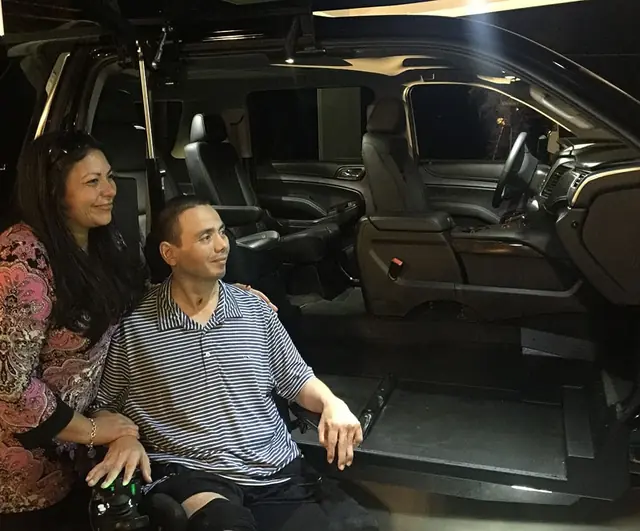 CPT. Luis Avila and his wife Claudia with the new 2017 Suburban Faces Of Valor USA purchased for their family.